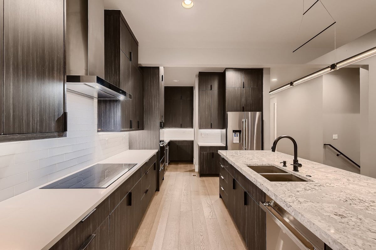 Modern kitchen in a custom home by Sheffield Homes, Denver, CO, featuring a large island and built-in appliances