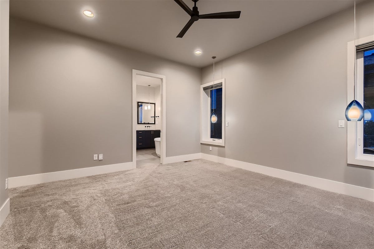 Spacious primary bedroom with an adjoining bathroom in a custom-built home by Sheffield Homes, Denver, CO