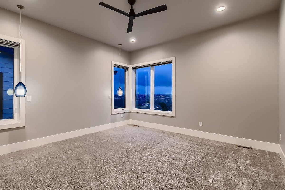 Spacious primary bedroom with large windows in a custom home by Sheffield Homes in Denver, CO