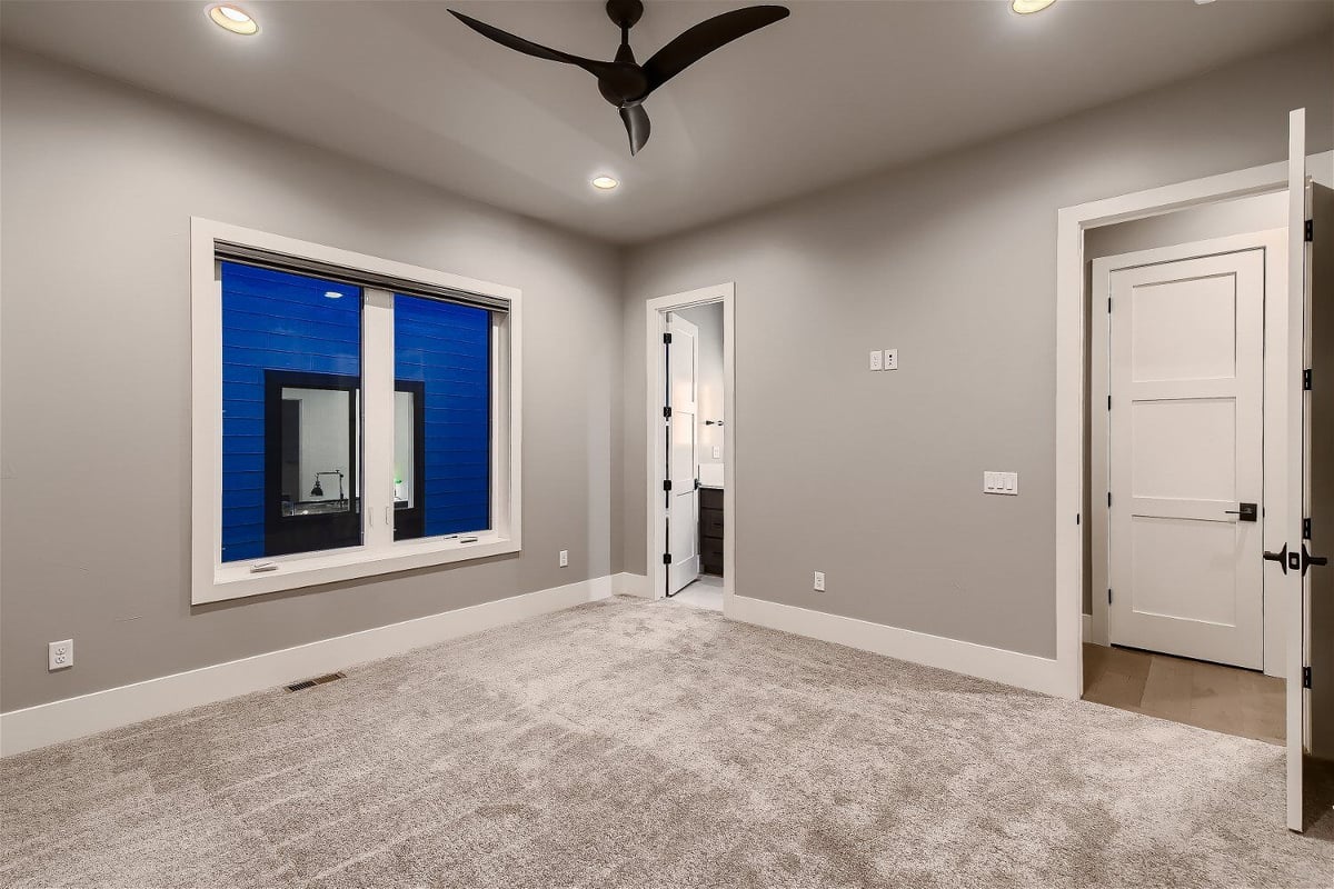 Spacious secondary bedroom with neutral tones in a custom home by Sheffield Homes, Denver, CO