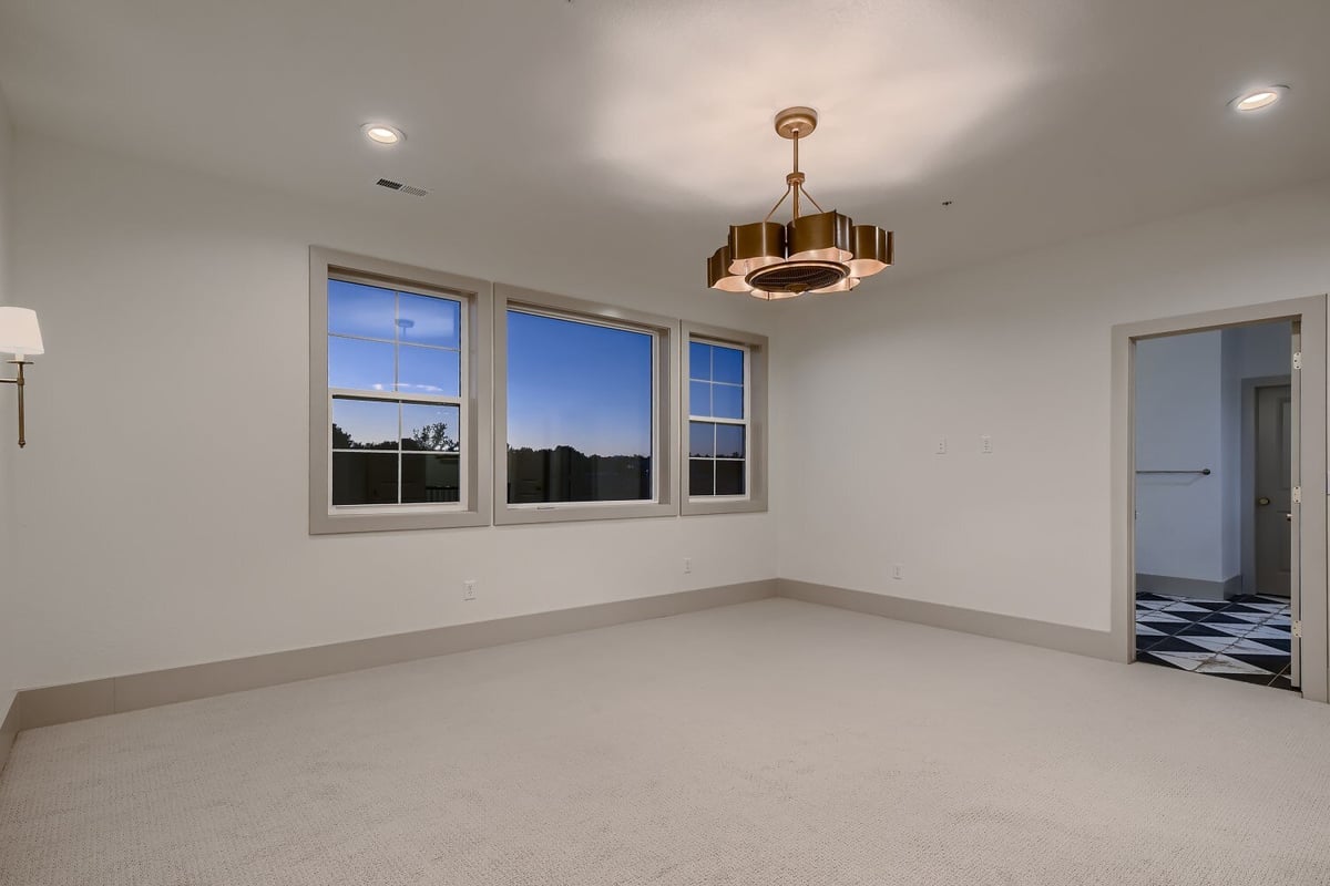 Bedroom with carpet flooring, featuring an elegant chandelier and recessed lights by Sheffield Homes in Westminster, CO