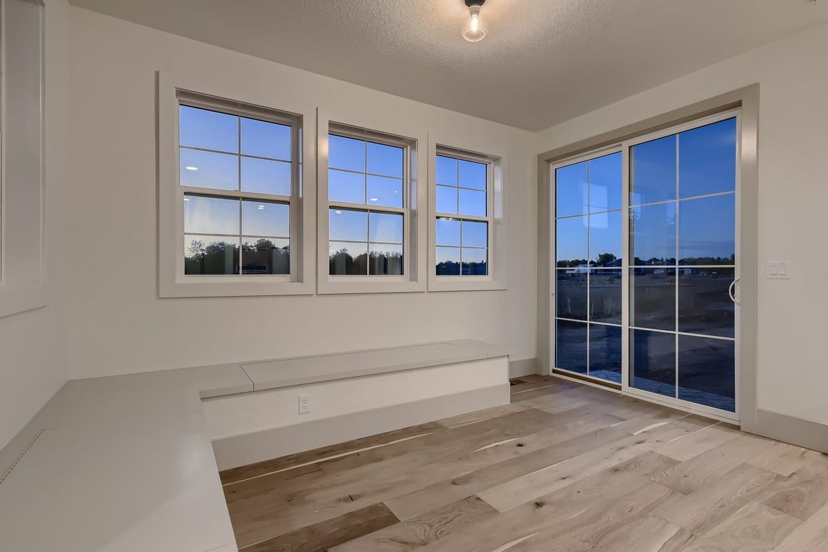 Breakfast area with vinyl flooring, wooden bench, and a couple of sliding windows in a Sheffield Homes home, Westminster, CO