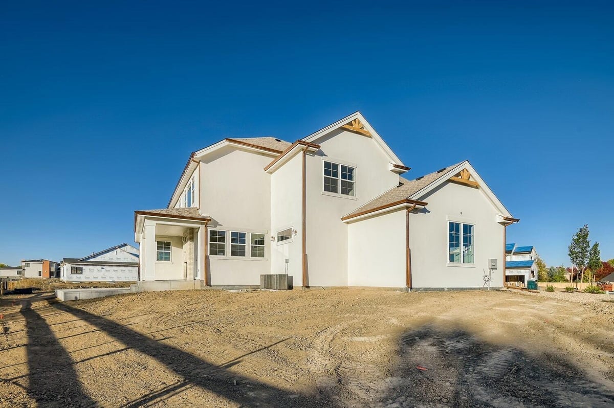 Daylight exterior long rear view of a custom home with a backyard, built by Sheffield Homes in Westminster, CO