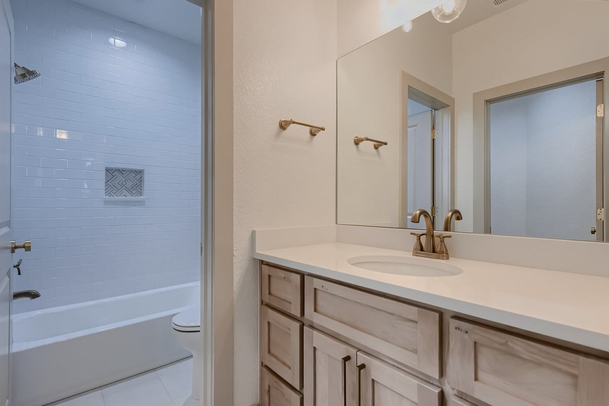 Second-floor bathroom with a modern vanity and a separate shower room in a Sheffield Homes home in Westminster, CO