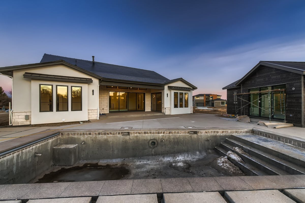 Backyard featuring a demolished pool, a guest house, and a home in the background, by Sheffield Homes in Westminster, CO