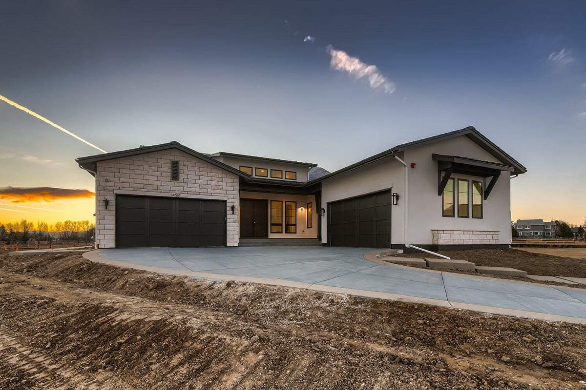 Long shot exterior front of a custom home with a paved driveway and a front yard, by Sheffield Homes in Westminster, CO