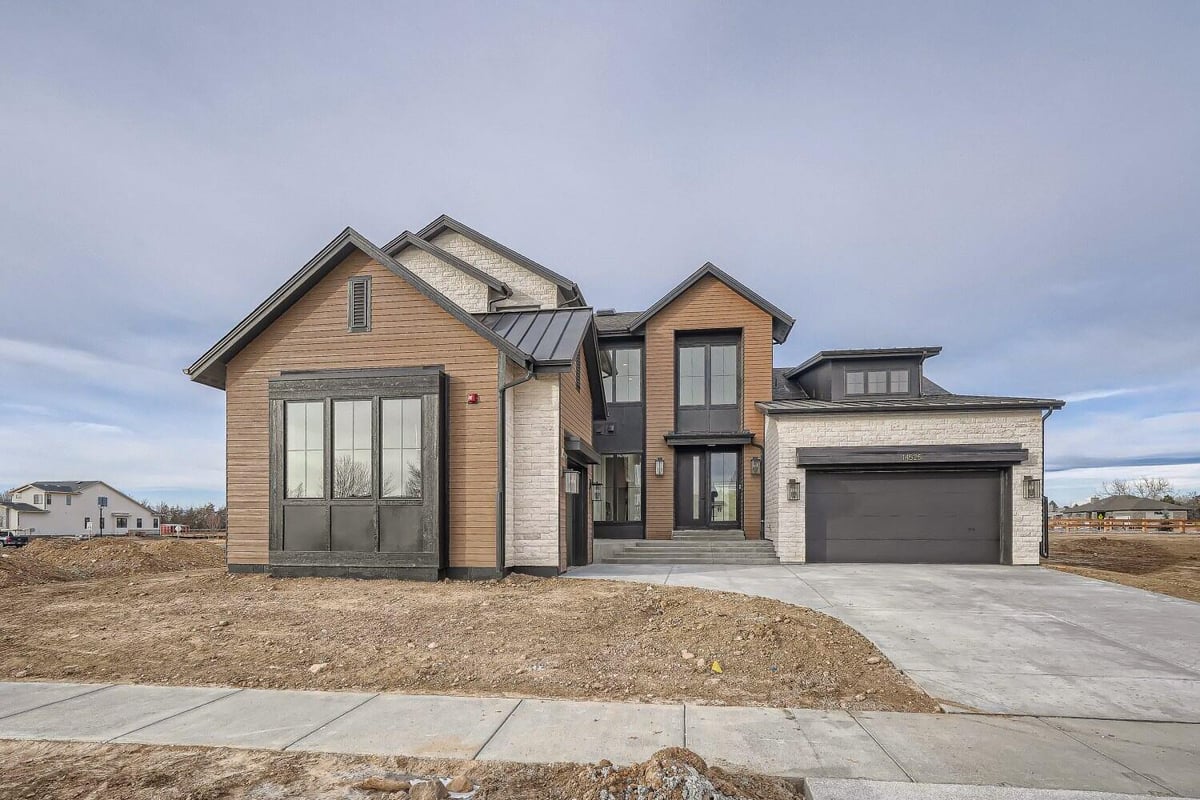 Exterior front daylight shot of a custom home with a garage and a small front yard, by Sheffield Homes in Westminster, CO