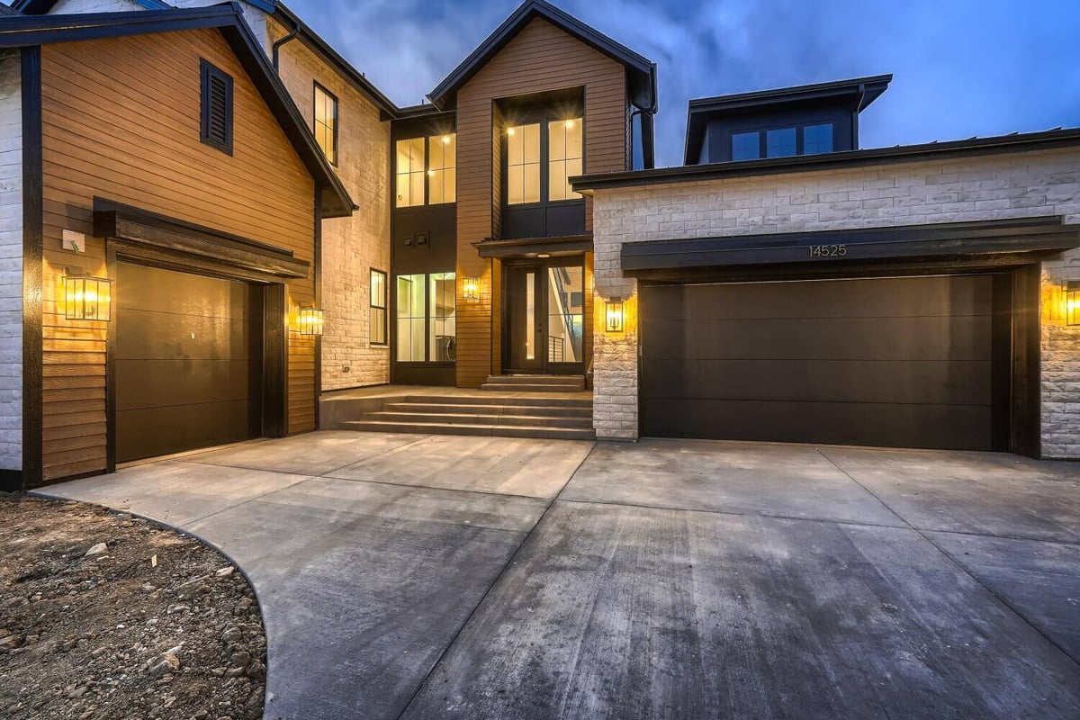 Exterior front entrance of a custom home with a main door and garage entrance, by Sheffield Homes in Westminster, CO