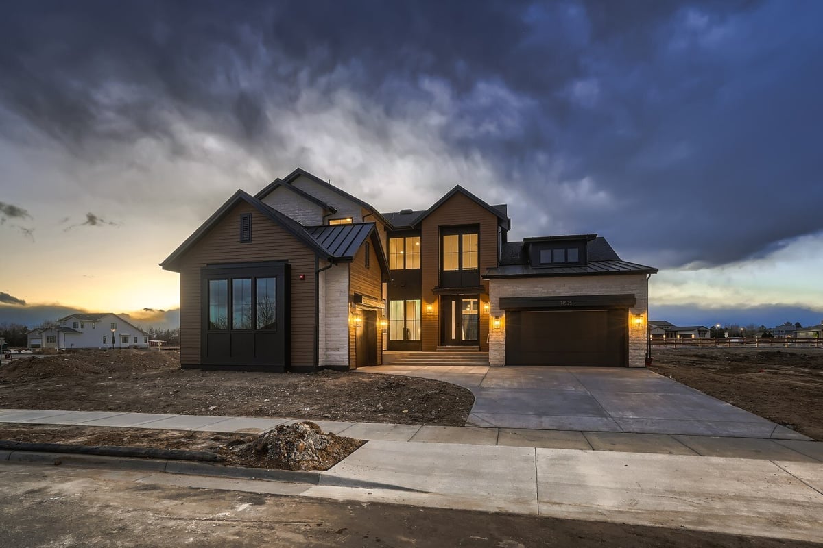 Exterior front view of a home with a garage and a drive-thru leading to the main road, by Sheffield Homes in Westminster, CO