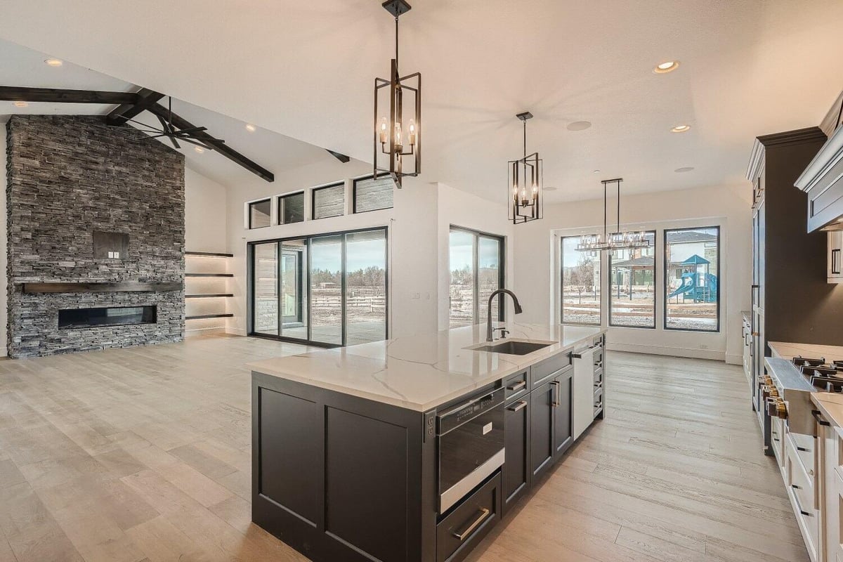 Island with a marble countertop, faucet, and multiple wooden and steel drawers in a home by Sheffield Homes, Westminster, CO