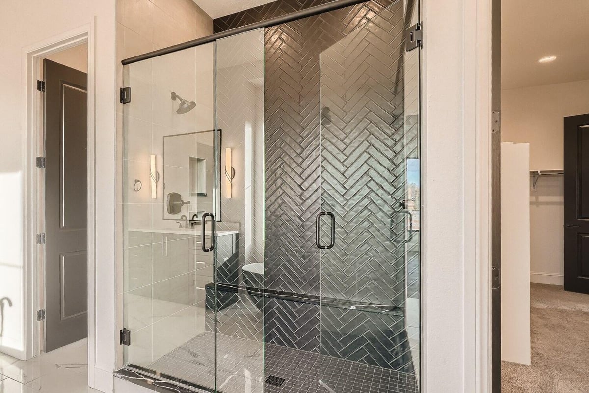 Primary bathroom with a separate glass-enclosed shower room and a modern vanity in a Sheffield Homes home in Westminster, CO