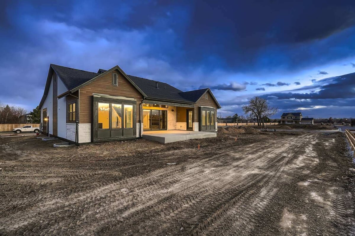 Rear exterior side view of a custom home with a covered backyard fence, by Sheffield Homes in Westminster, CO