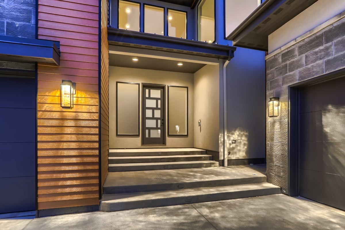 Exterior front entry with multi-color lights and steps leading to the front door of a Sheffield Homes home in Westminster, CO