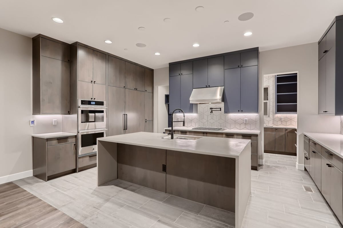 Kitchen featuring an island, wooden cabinetry, and stainless steel appliances in a Sheffield Homes home in Westminster, CO