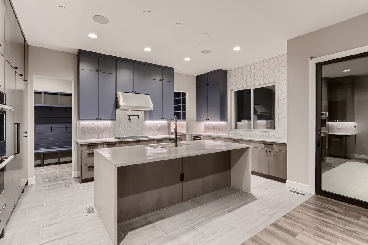 Modern kitchen featuring a center island, wooden cabinetry, and steel appliances in a Sheffield Homes home in Westminster, CO