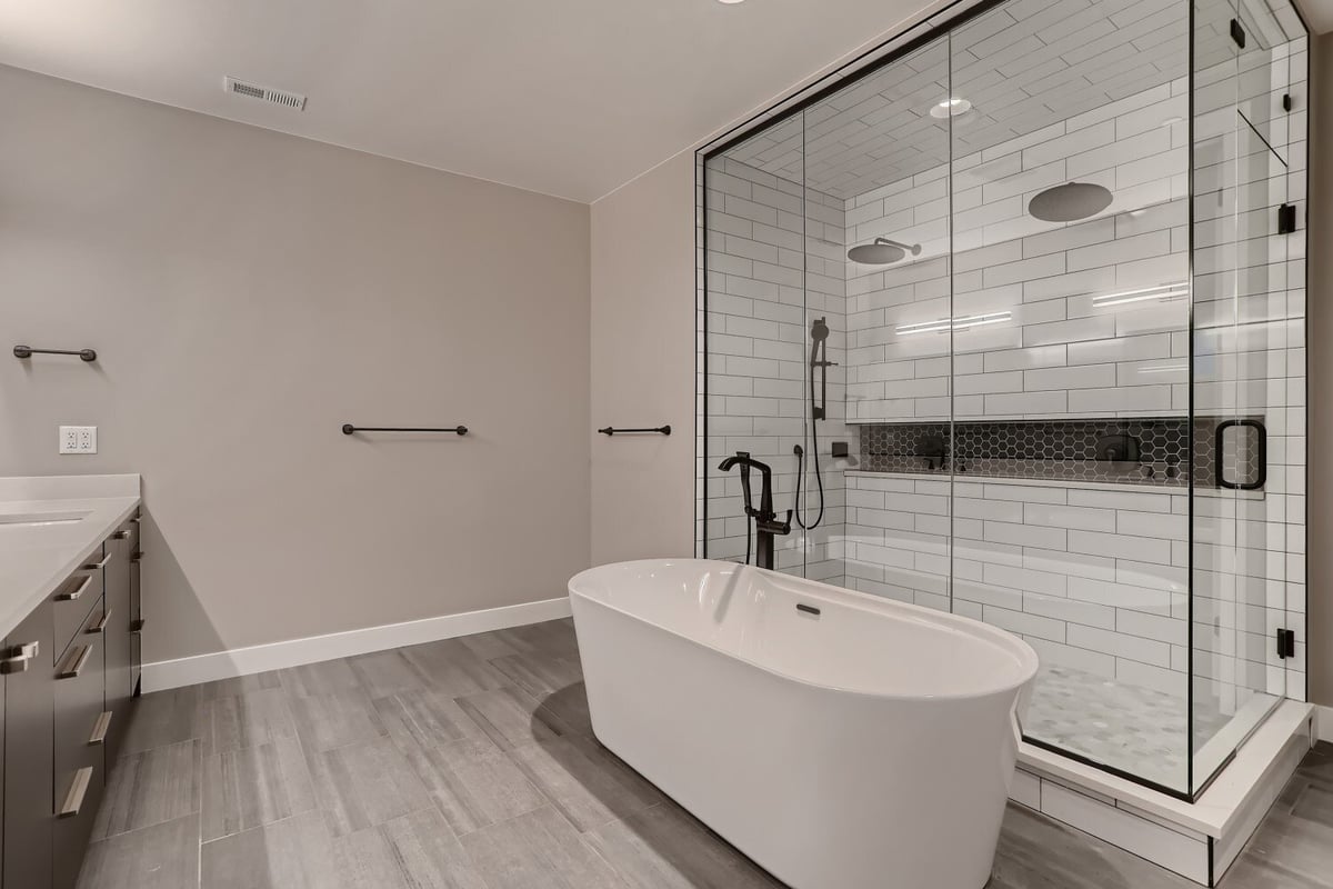 Primary bathroom featuring a bathtub with a standing faucet and a shower room in a Sheffield Homes home in Westminster, CO