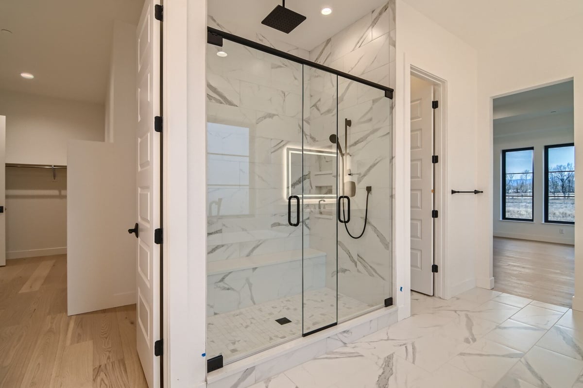 Primary bathroom featuring a glass-enclosed shower room with modern fixtures in a Sheffield Homes home in Westminster, CO