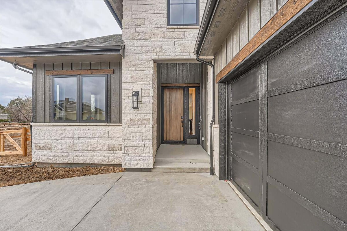 Exterior front entrance of a custom home with a pathway leading to the main door, by Sheffield Homes in Westminster, CO