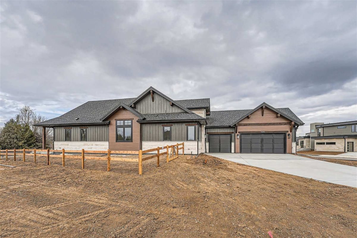 Exterior front of a home with a front yard and a paved driveway leading from the garage, by Sheffield Homes, Westminster, CO