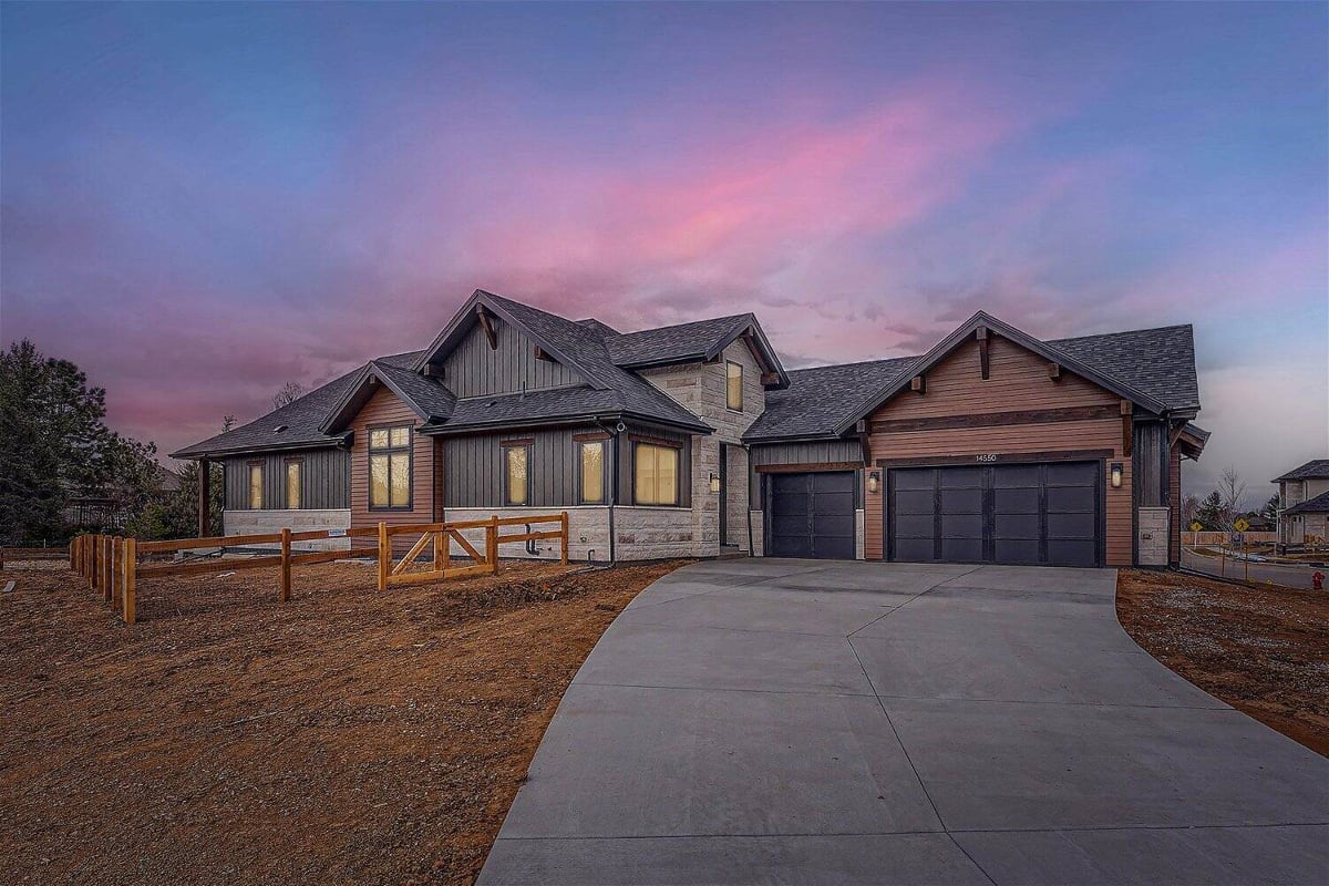 Exterior front of a home with a yard and a paved driveway leading from the garage, by Sheffield Homes in Westminster, CO