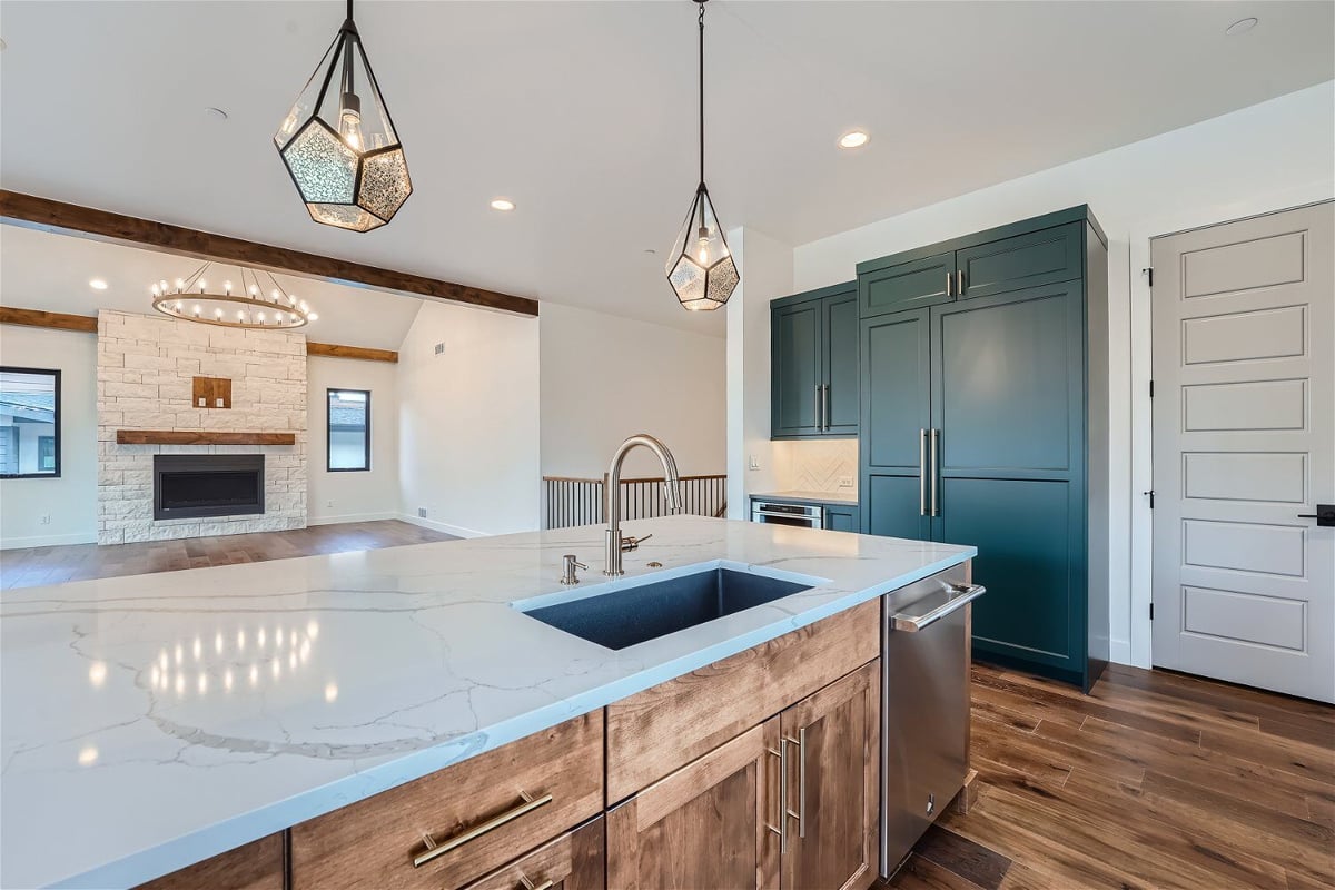 Kitchen island featuring a granite countertop, steel drawers, and a wooden base in a Sheffield Homes home in Westminster, CO