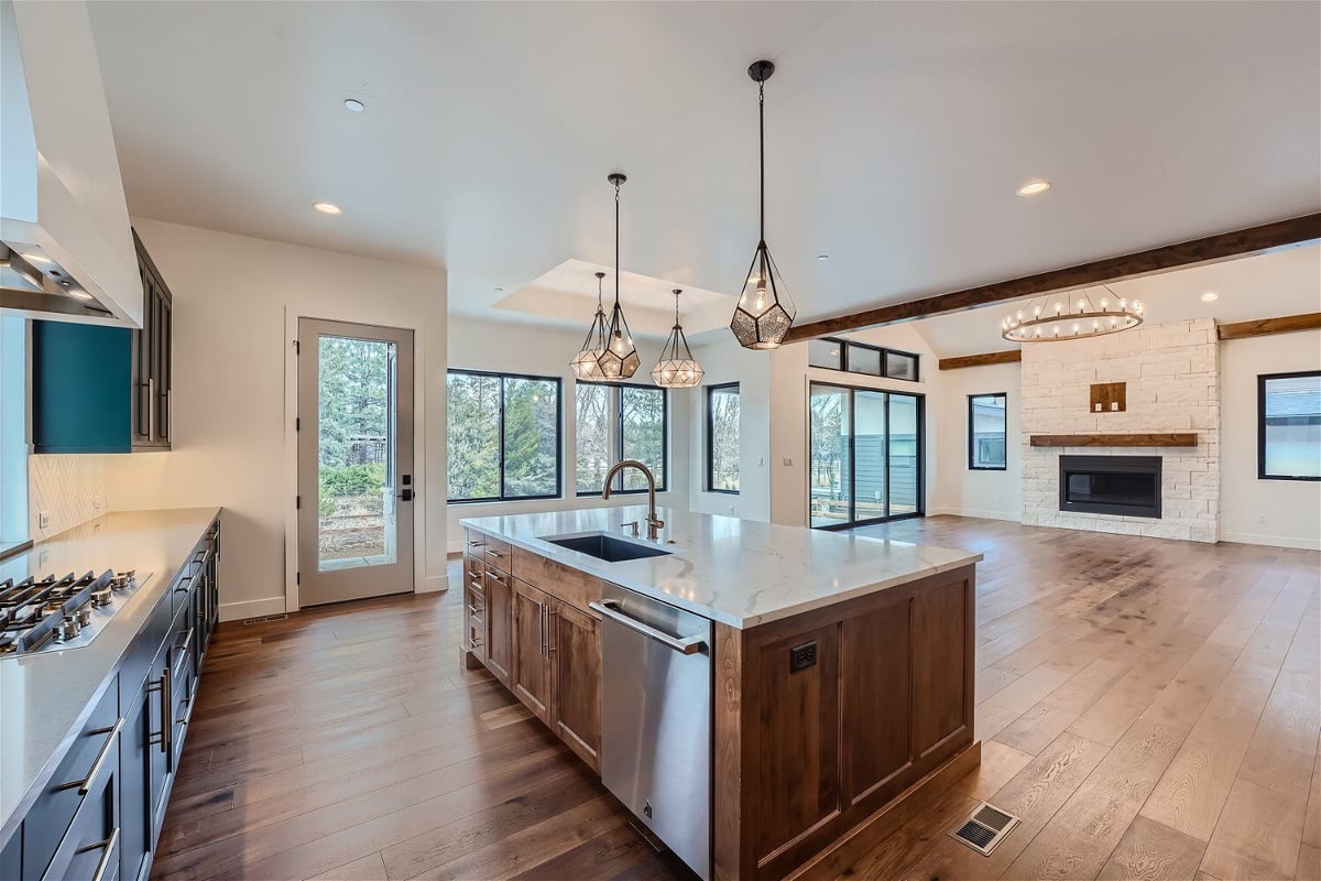 Open kitchen with a rear counter for stove fixtures and an island for serving in a Sheffield Homes home in Westminster, CO