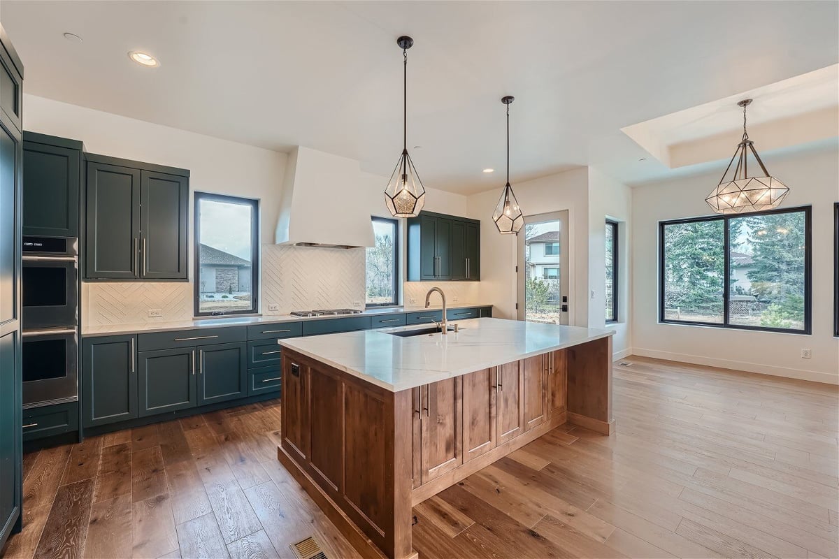 Open kitchen with counter cabinetry, wall closets for storage, and an island in a Sheffield Homes home in Westminster, CO