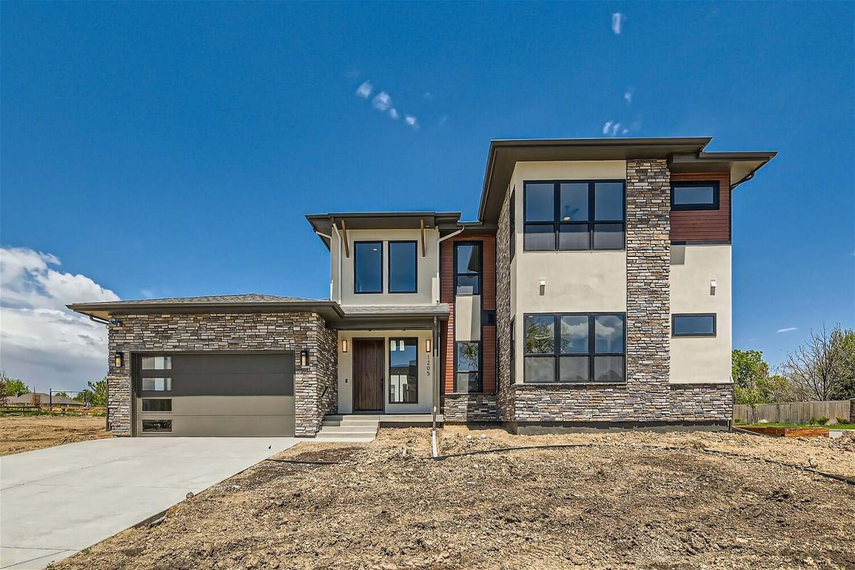 Daylight exterior front view of a custom home with minimal stone accent work, by Sheffield Homes in Westminster, CO