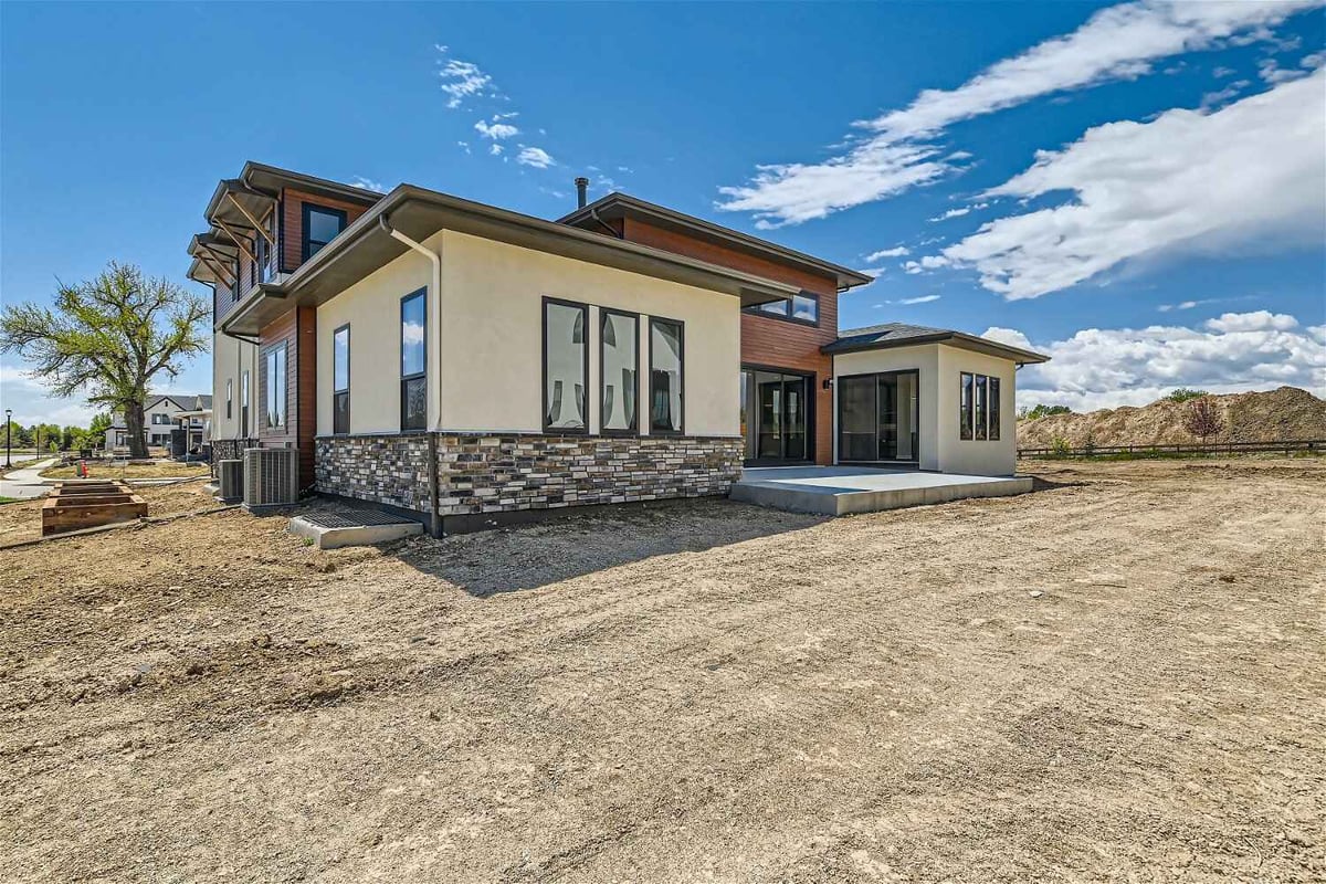 Daylight exterior rear view of a backyard of a custom home by Sheffield Homes in Westminster, CO