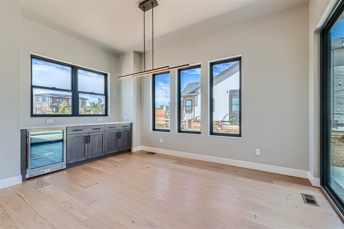 Dining room with cabinets, windows, and a chandelier for added elegance in a Sheffield Homes home in Westminster, CO