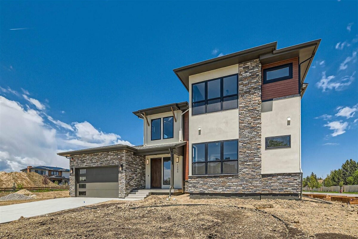 Exterior front view of a custom home with minimal stone accent work, by Sheffield Homes in Westminster, CO