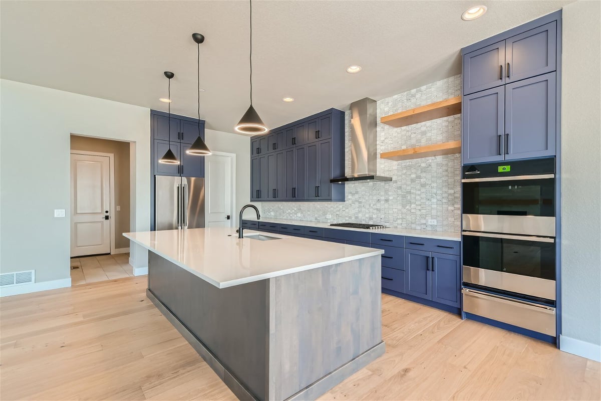 Kitchen with a central island, rear cabinetry, and stainless steel appliances in a Sheffield Homes home in Westminster, CO