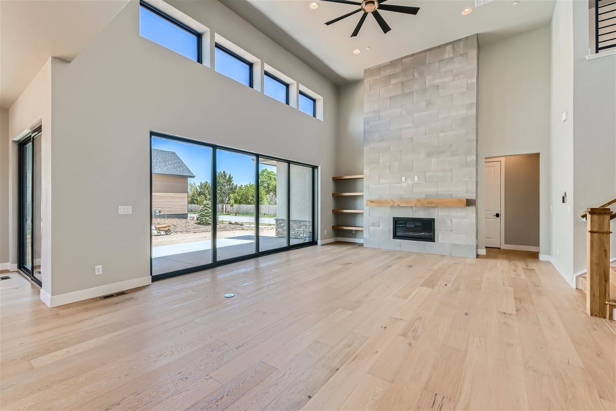 Spacious living room with vinyl flooring and large sliding doors leading outside, by Sheffield Homes in Westminster, CO