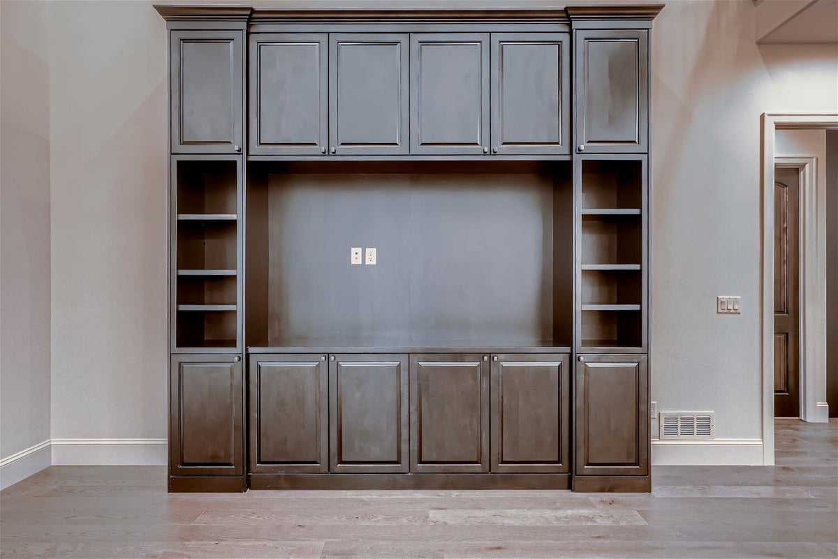 Close-up of a brown wooden closet placed with the living room wall in a Sheffield Homes home in Westminster, CO