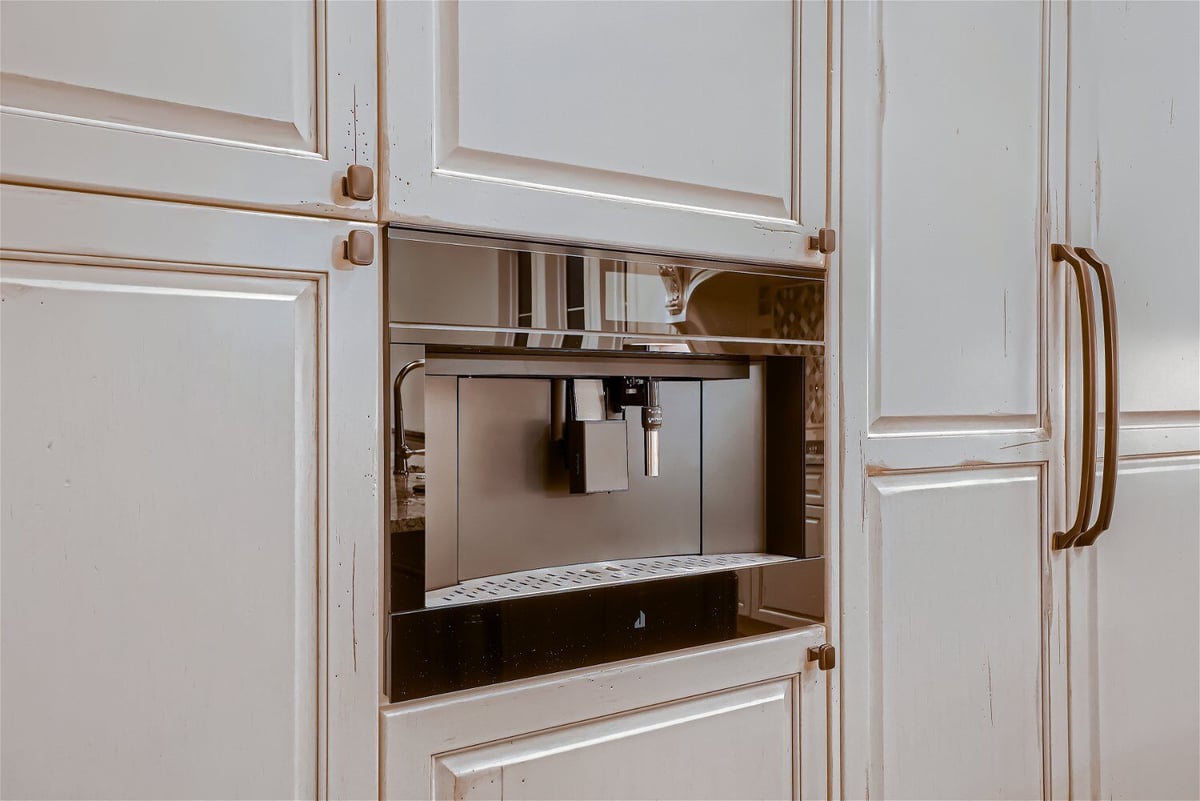 Close-up of the gas connections fixture at the base of the cabinets in a Sheffield Homes home in Westminster, CO