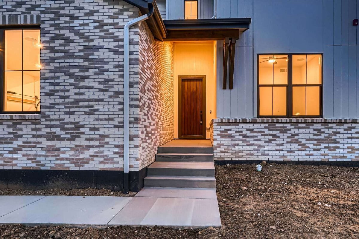 Exterior front entrance of a custom home with a walkway leading to the main door, by Sheffield Homes in Westminster, CO