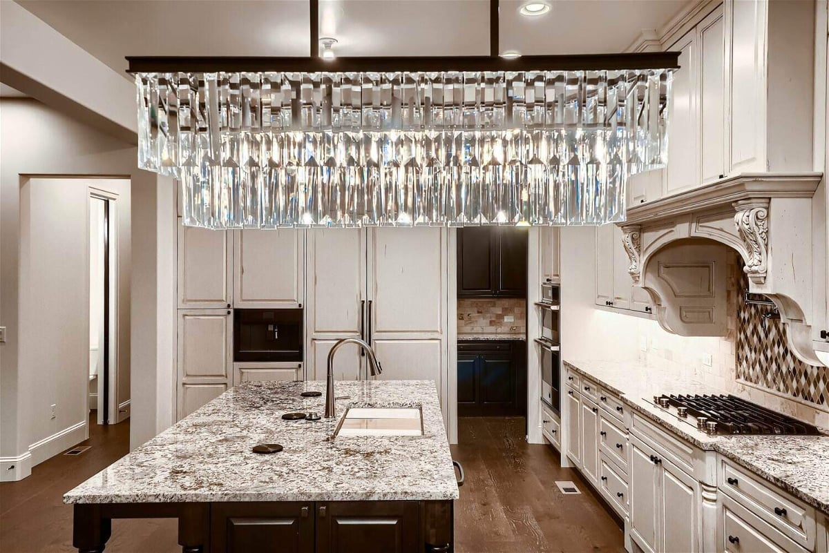 Kitchen featuring a close-up view of the chandelier and a central island, in a Sheffield Homes home in Westminster, CO