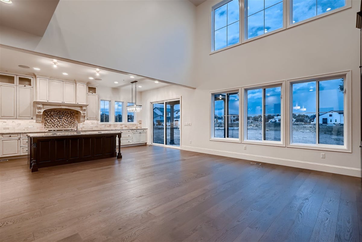 Living room featuring a retro-style island and a rear counter with white cabinetry, by Sheffield Homes in Westminster, CO