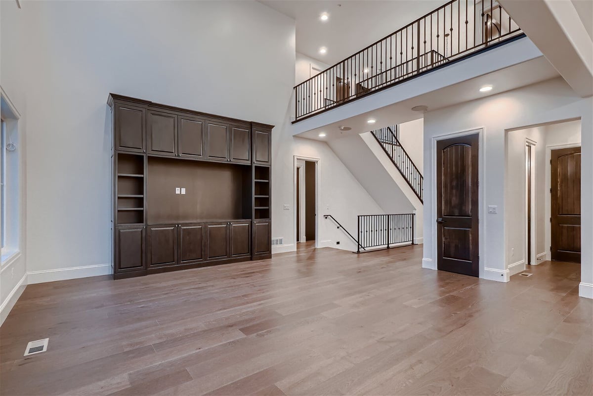 Living room with low beams and a wooden closet placed with the wall, by Sheffield Homes in Westminster, CO