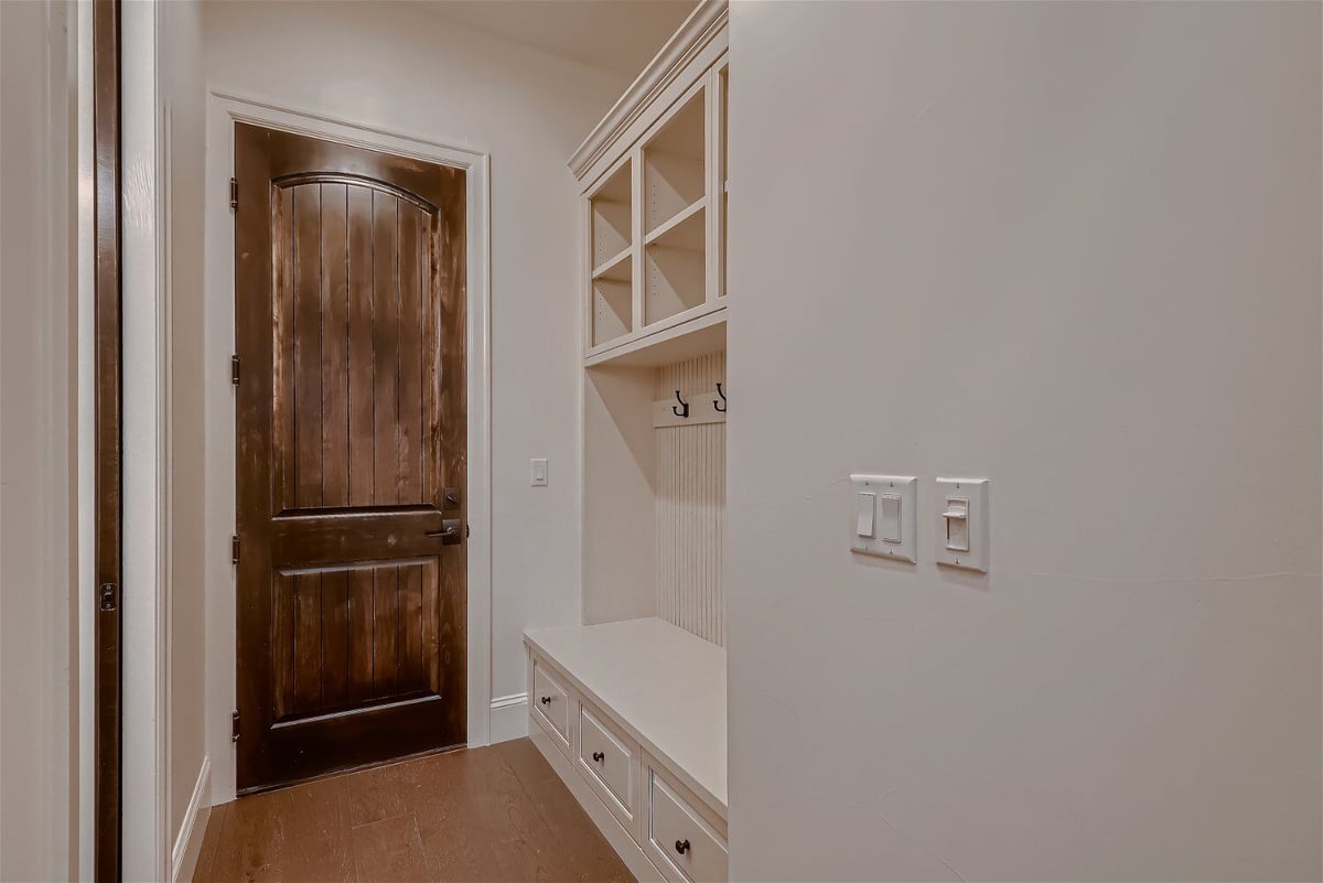 Mudroom with a wooden closet for cloth hanging and footwear storage in a Sheffield Homes home in Westminster, CO