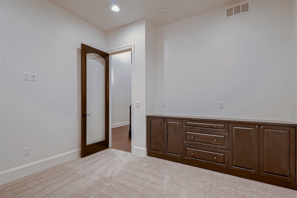 Office room with carpet flooring and a horizontal wooden closet in a Sheffield Homes home in Westminster, CO