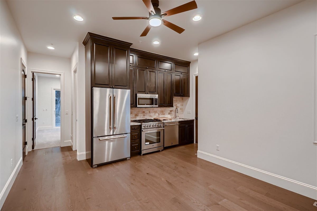 Open kitchen with modern cabinetry and stainless steel appliances in a Sheffield Homes home in Westminster, CO