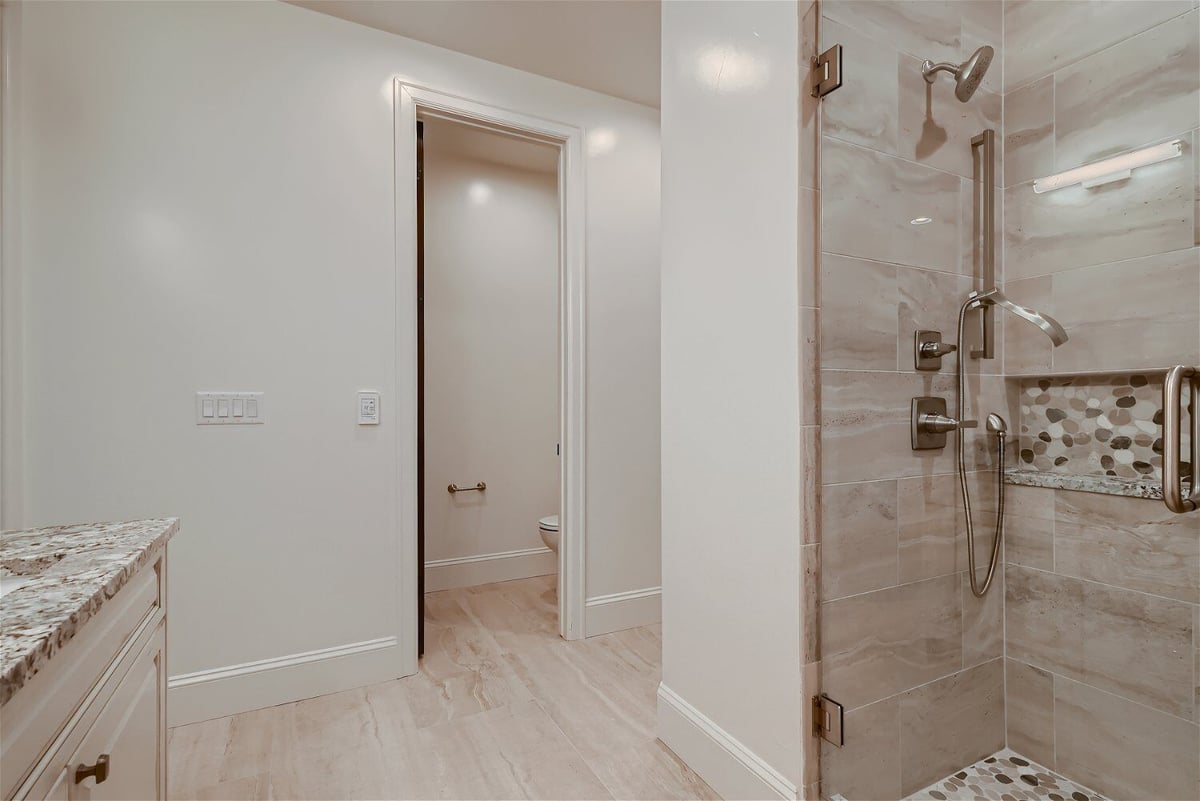 Second-floor bathroom with white paint and a glass-enclosed shower in a Sheffield Homes home in Westminster, CO