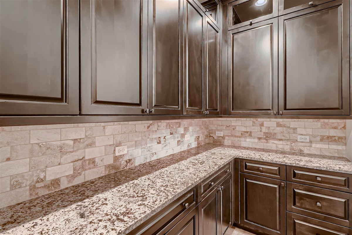 Wetbar counter with a wooden base and wall-mounted cabinetry in a Sheffield Homes home in Westminster, CO