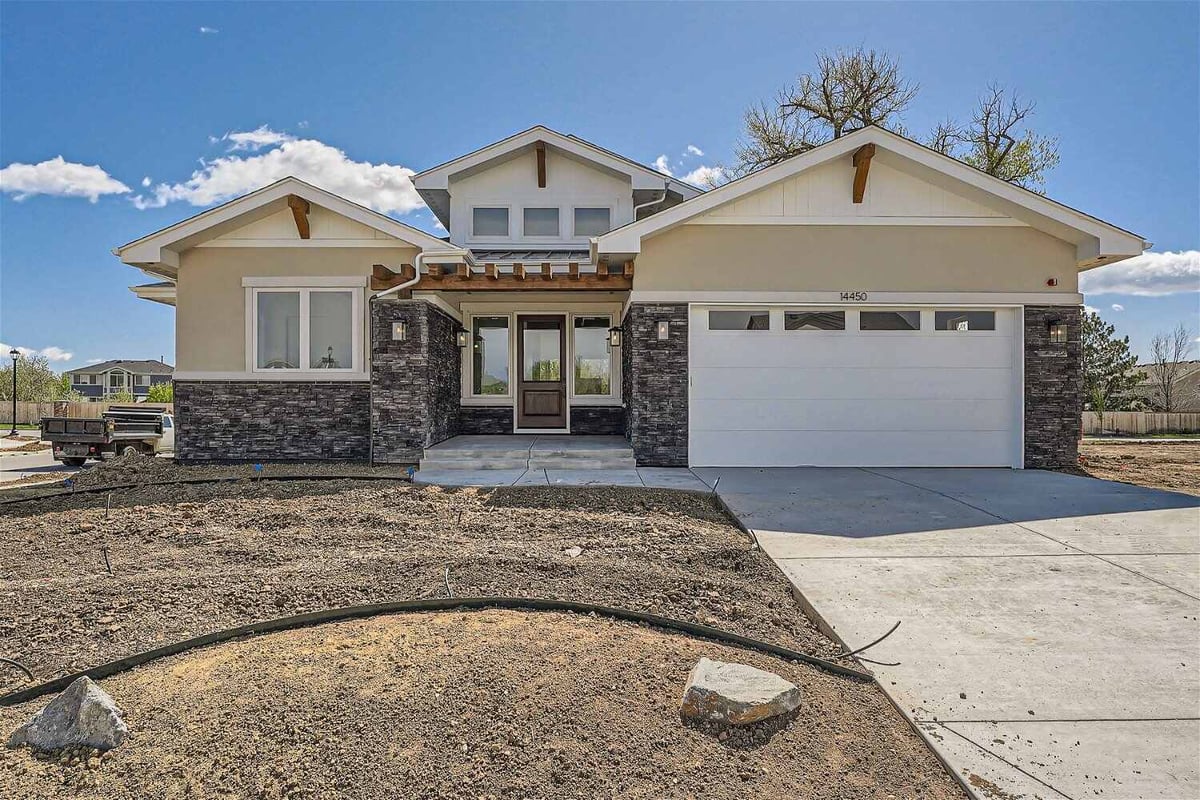 Exterior front view of a custom home with a garage driveway and a front yard, built by Sheffield Homes in Westminster, CO