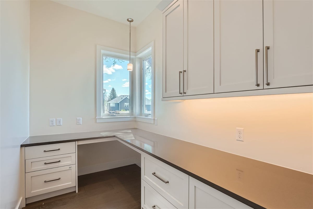 Kitchen counter with a sleek top, wooden cabinets, and drawers in a Sheffield Homes home in Westminster, CO