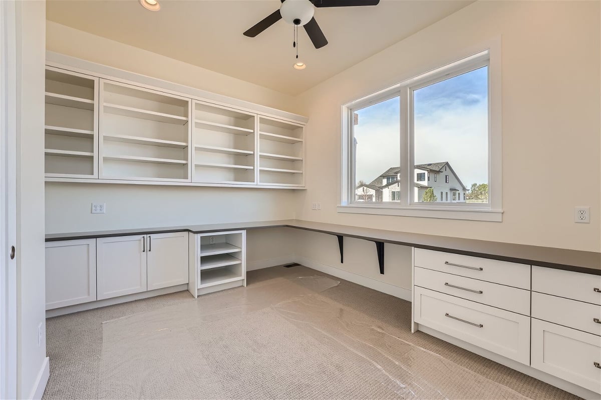 Office with wall-mounted closets and side dressers offering ample space in a Sheffield Homes home in Westminster, CO