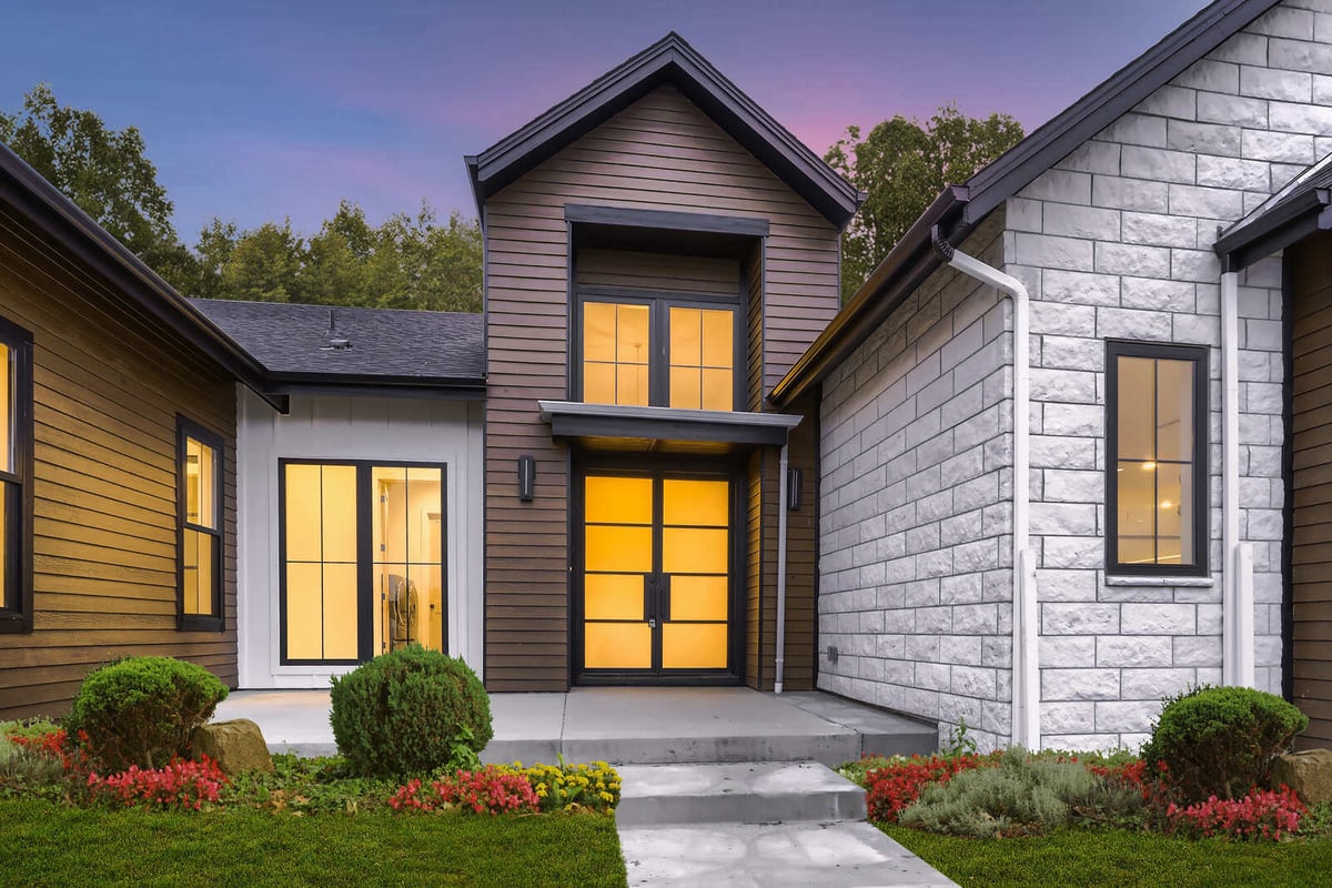 Close-up of the front entry of a custom home by Sheffield Homes in Denver, CO, highlighting modern siding and elegant landscaping