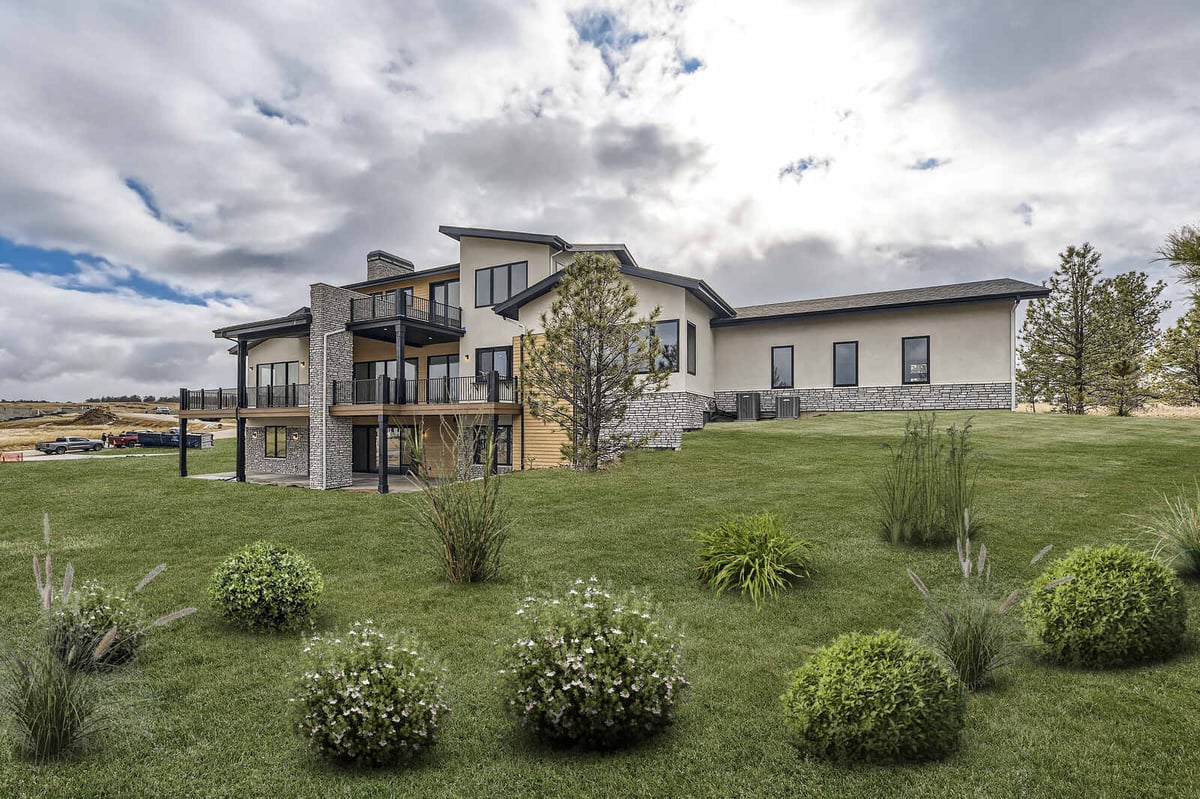 Exterior view of a custom-built modern home by Sheffield Homes in Denver, CO, showcasing a spacious backyard and multiple balconies