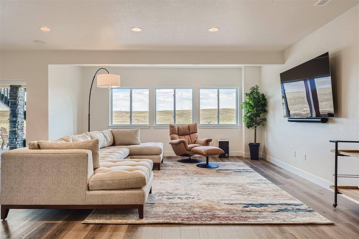 Finished basement family room with large sectional sofa by Sheffield Homes in Denver, CO